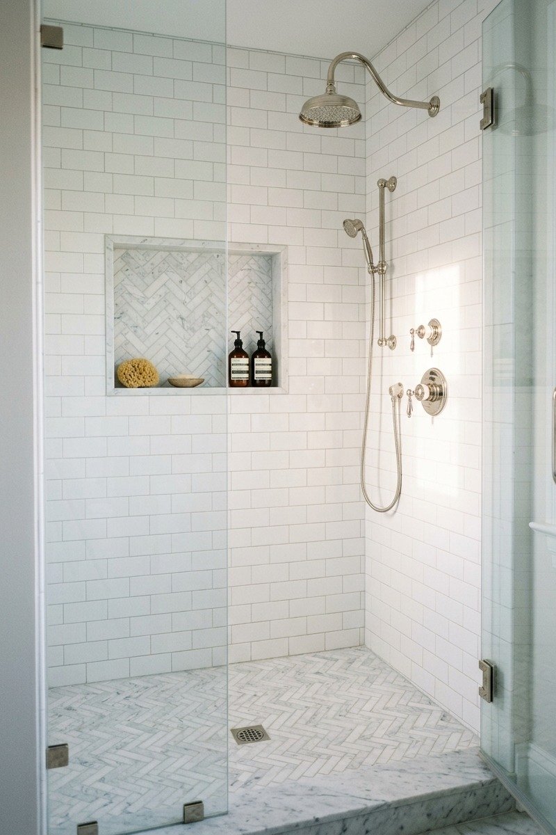 Marble herringbone mosaic shower floor and matching niche